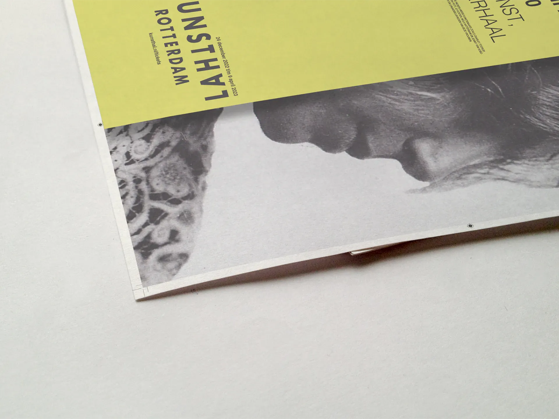 Close-up of the poster corner — the Kunsthal Rotterdam wordmark and B&W portrait cropped at the edge, showing the print detail and typographic tension