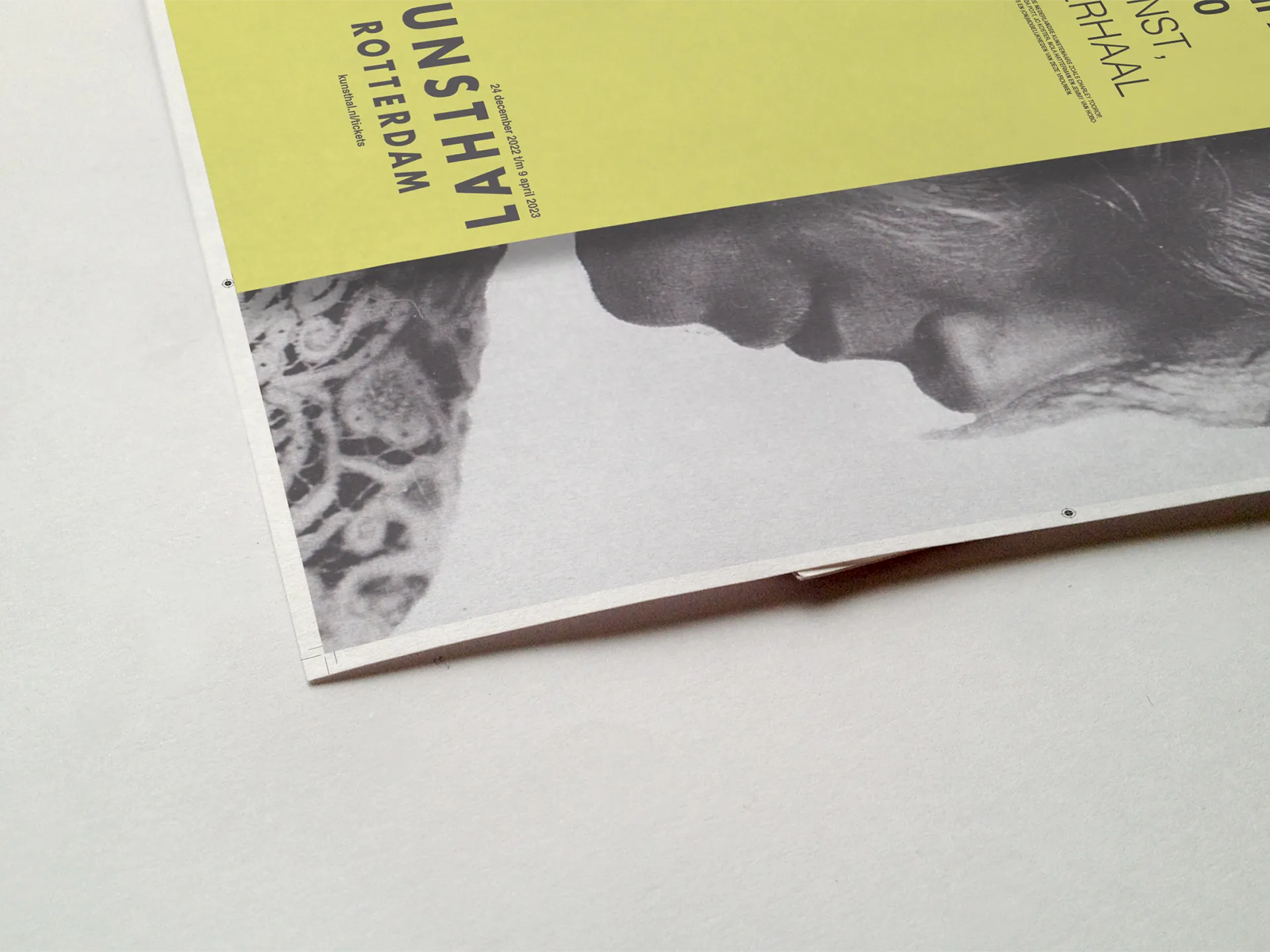 Close-up of the poster corner — the Kunsthal Rotterdam wordmark and B&W portrait cropped at the edge, showing the print detail and typographic tension