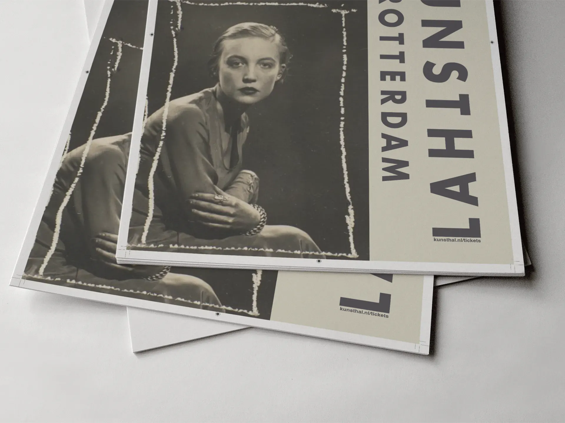 Close-up of poster version 2 — the vintage seated portrait alongside the vertical Kunsthal wordmark, shown as stacked flat print sheets