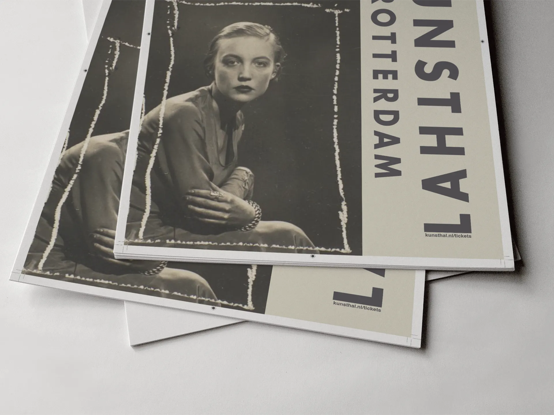 Close-up of poster version 2 — the vintage seated portrait alongside the vertical Kunsthal wordmark, shown as stacked flat print sheets